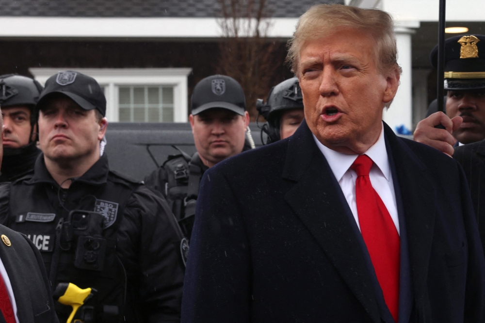 File photo of former US President Donald Trump speaking to the media after attending the wake of slain NYPD Officer Jonathan Diller at the Massapequa Funeral Home on March 28, 2024 in Massapequa, New York. — AFP pic