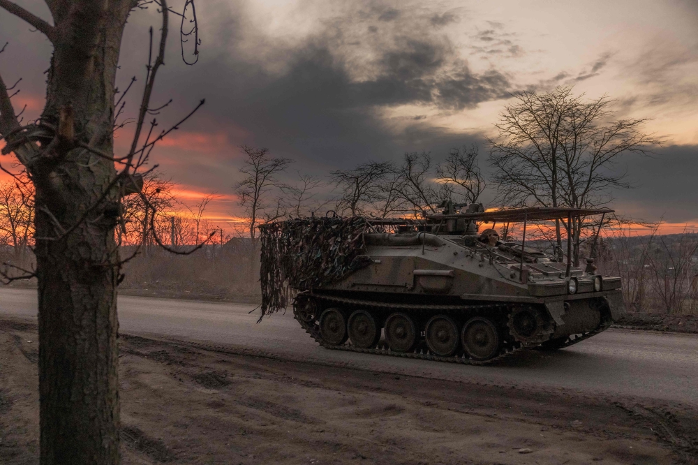 A Ukrainian serviceman drives a British FV103 Spartan armoured personnel carrier on a road that leads to the town of Chasiv Yar, in the Donetsk region, on March 30, 2024, amid the Russian invasion of Ukraine. — AFP pic