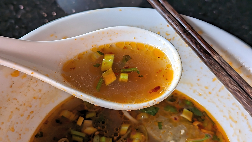 Look past the red tinge from the chilli oil to see that the broth of the Signature Braised Beef Noodles is darker than most.