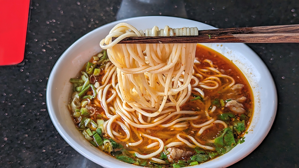 The soft wheat noodles here are made in the same style as Lanzhou lamian, though I would refrain from calling them hand-pulled.