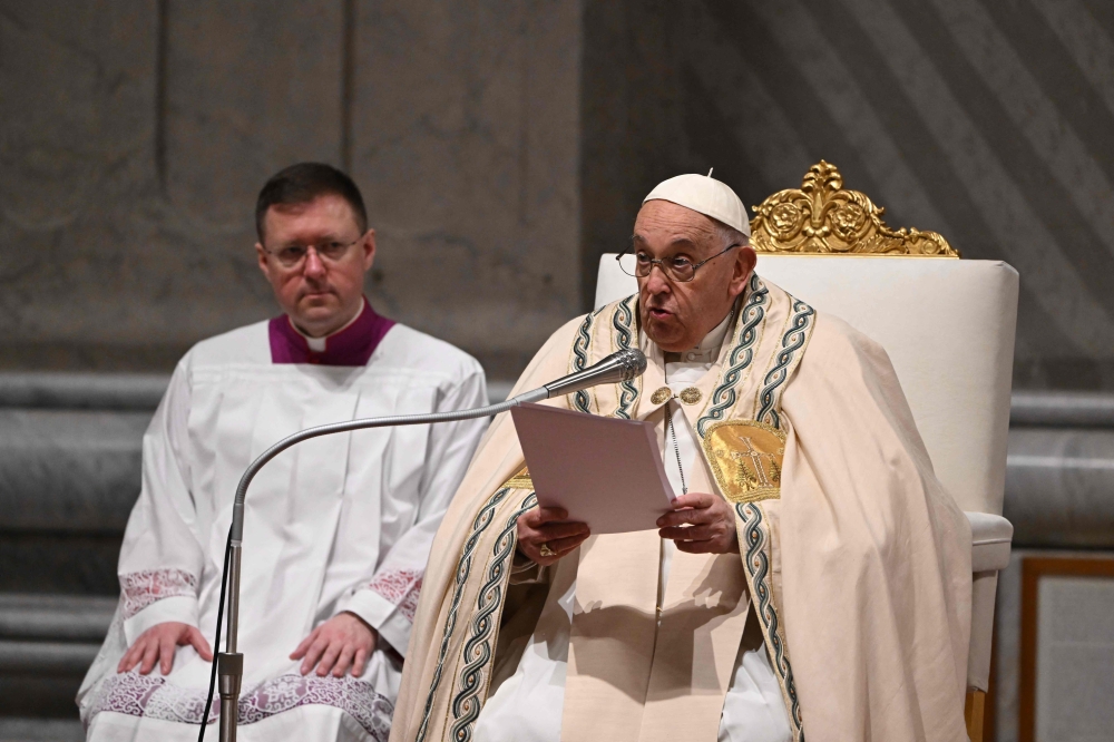 Pope Francis presides the Easter vigil as part of the Holy Week celebrations, at St Peter’s Basilica in the Vatican on March 30, 2024. — AFP pic
