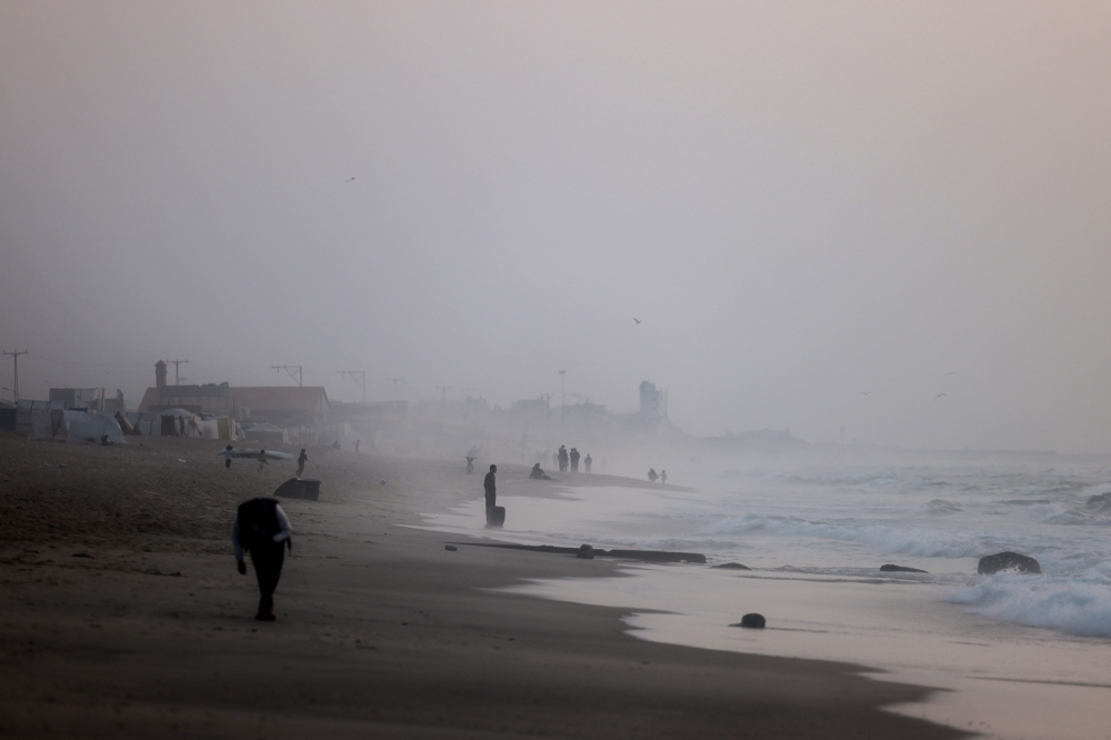 Palestinians are seen on the beach in Rafah in the southern Gaza Strip on March 30, 2024 amid the ongoing conflict in the Palestinian territory between Israel and the militant group Hamas. — AFP pic