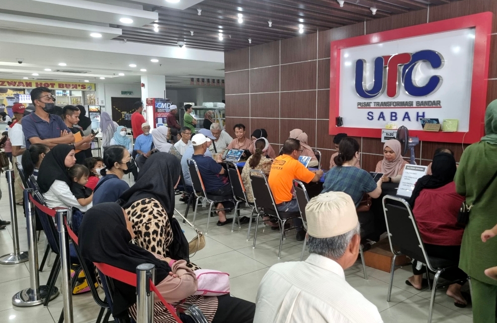 People are seen at the counters at the Kota Kinabalu Urban Transformation Centre to do their Central Database Hub (Padu) registration March 31, 2024. — Bernama pic