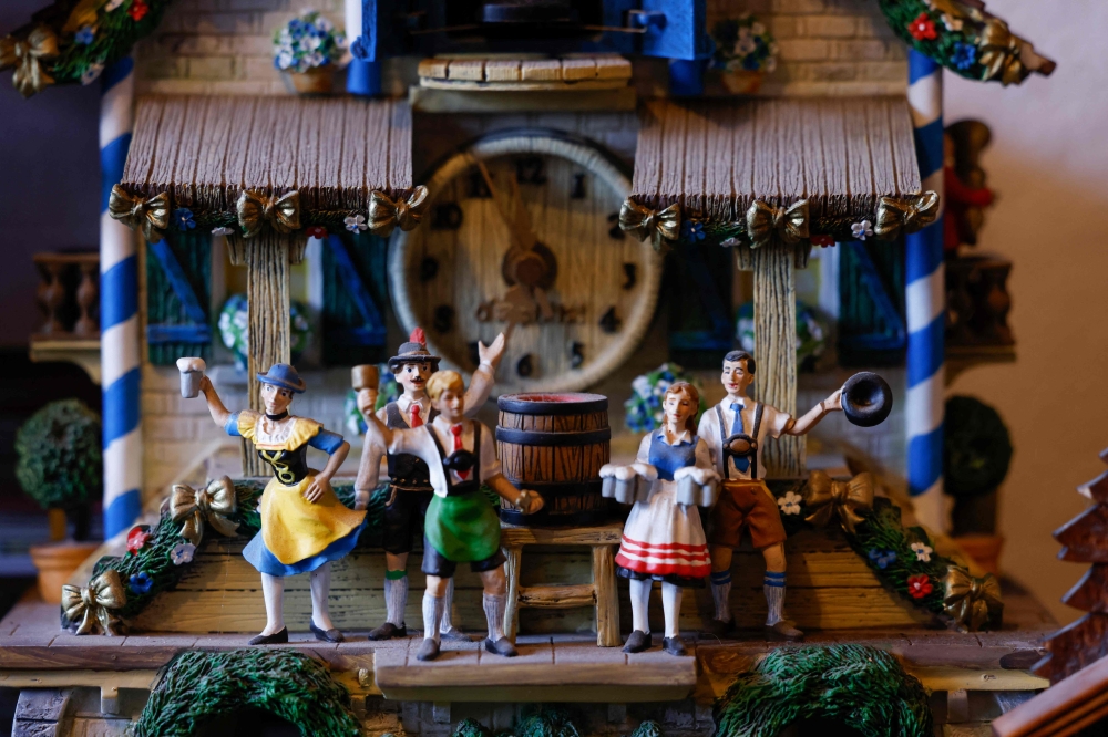 A Bavarian themed clock as part of the collection of Werner Stechbarth is pictured in his living room in Munich March 22, 2024. — AFP pic