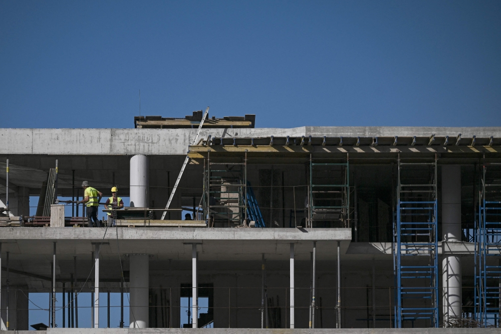 This photograph taken on March 30, 2024 shows an apartment building under construction at a southern suburb of Athens. Greece tightened its Golden Visa rules raising the required investment total for a third national to secure the residence permit to €250,000-800,000 in an effort to alleviate the country’s housing crisis. — AFP pic