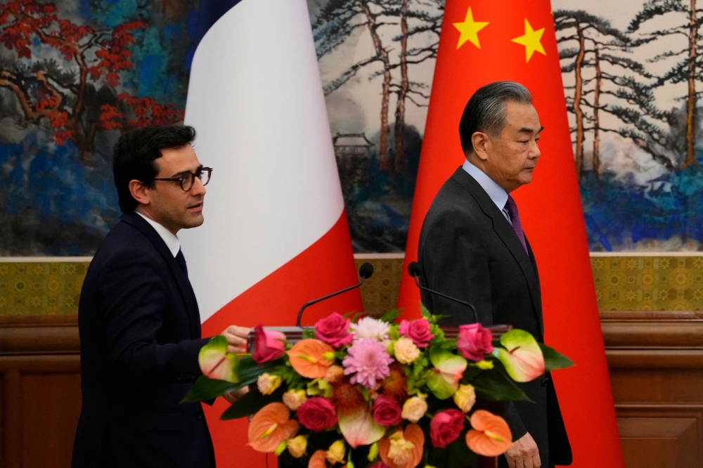 France’s Foreign Minister Stephane Sejourne alongside his local counterpart Wang Yi at a press conference in Beijing. — AFP pic