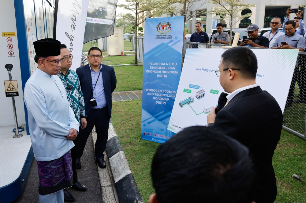 Prime Minister Datuk Seri Anwar Ibrahim listens to an explanation about the mobile hydrogen refuelling unit during a demonstration of the usage of the unit at Complex C, Federal Government Administrative Centre, Putrajaya, April 1, 2024. — Picture by Miera Zulyana