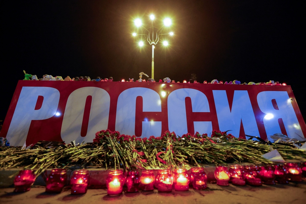 Candles are lit during a vigil in memory of the victims of a shooting attack at the Crocus City Hall concert venue outside Moscow, in Donetsk, Russian-controlled Ukraine, March 30, 2024. — Reuters pic