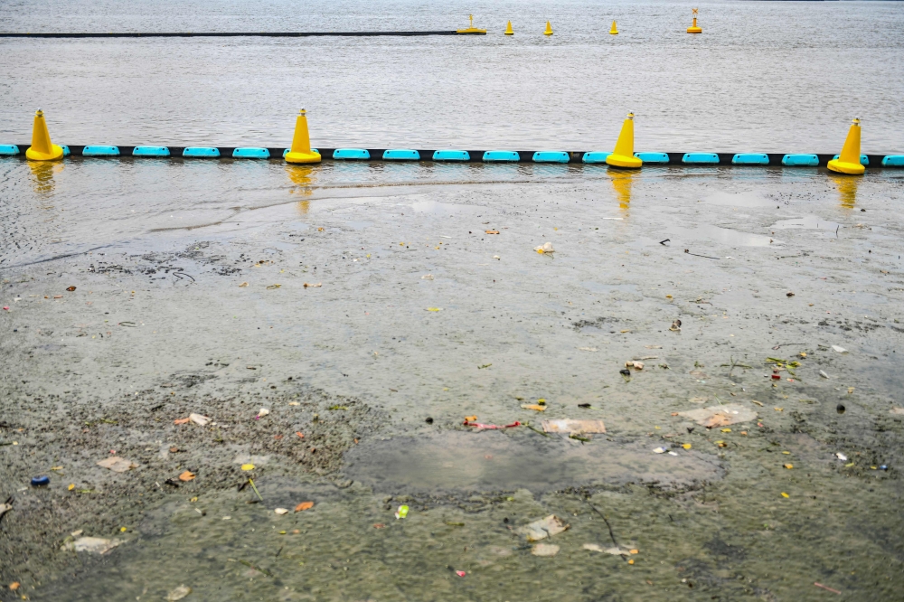 Muddy polluted water is pictured near the Ocean Cleanup's Interceptor, which captures floating plastic and trash before it reaches the ocean, during a press visit on the Chao Phraya river in Bangkok on March 26, 2024. — AFP pic