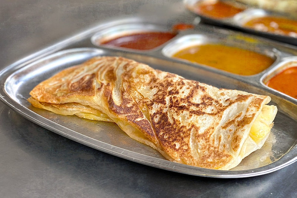 The caramelised crust of a 'roti pisang' elevates the sliced bananas within. — Pictures by CK Lim