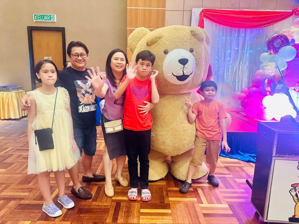 Jennifer Balanting, 42 (third from left) with her eldest son Ashton (fourth from left) who was diagnosed with mild autism at the age of 3. — Picture courtesy of Jennifer Balanting