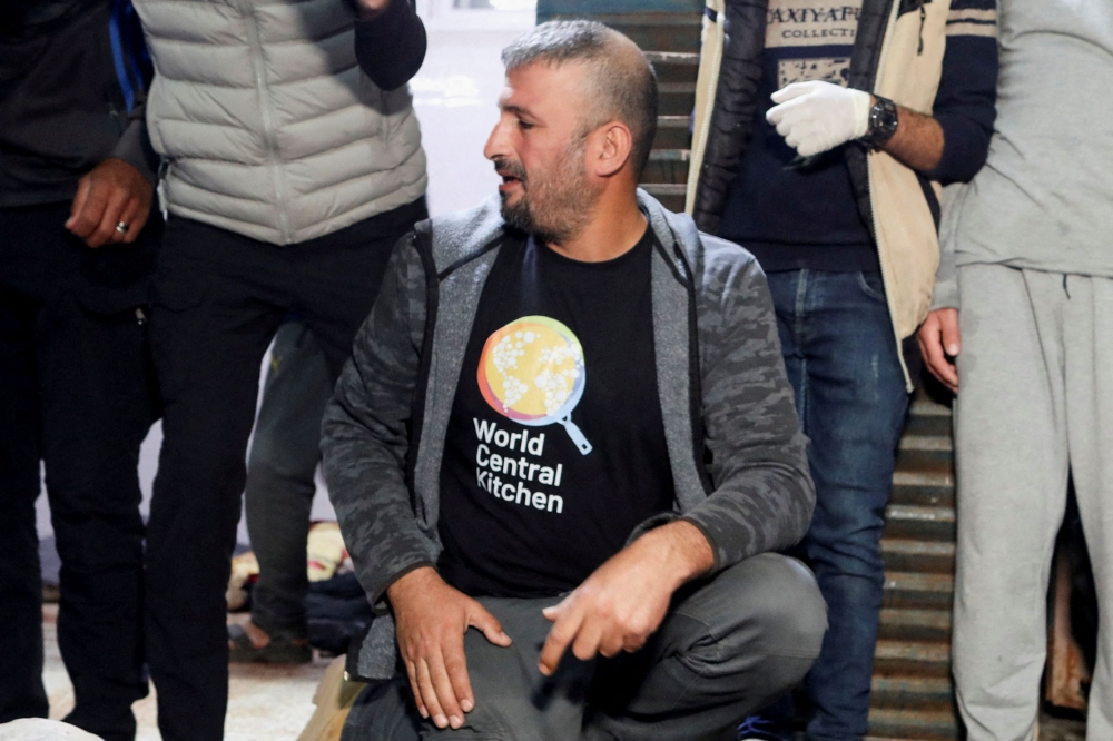 A mourner reacts next to the bodies of employees from the World Central Kitchen (WCK) non-governmental organization, including foreigners, who were killed in an Israeli airstrike according to the Hamas-run Gaza government media office but the Israeli military said it was conducting a thorough review at the highest levels to understand the circumstances of this 