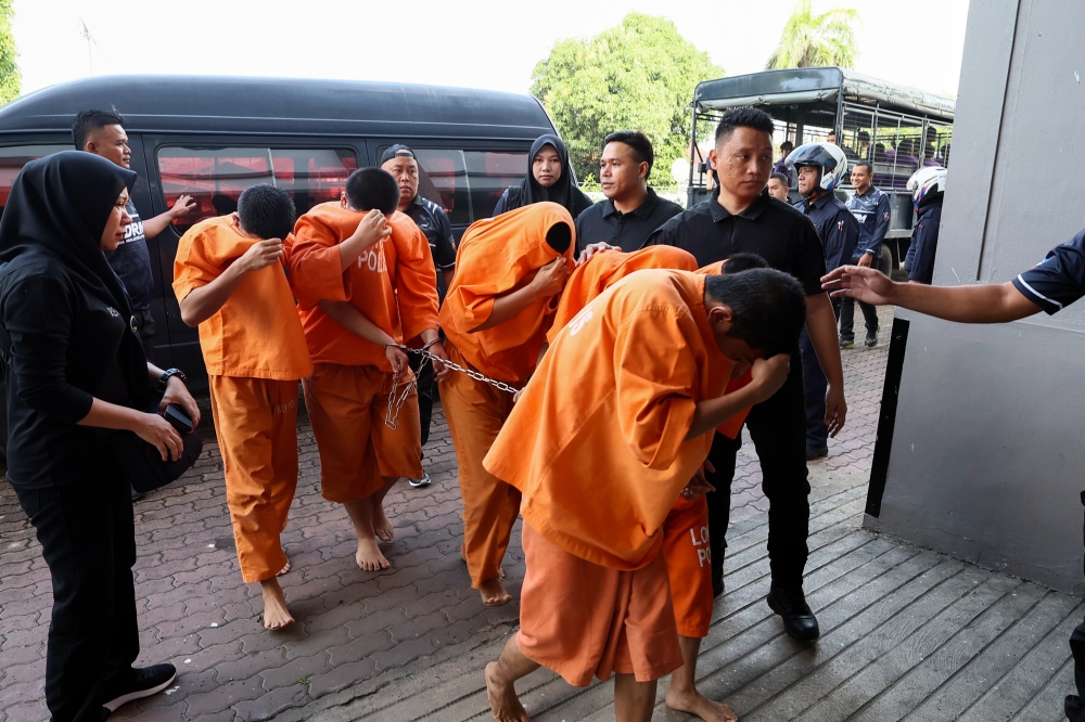 The accused, aged between 16 and 19, are led to the Magistrate’s Court in Lahad Datu April 2, 2024. — Bernama pic