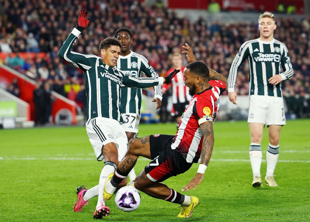 Manchester United’s Raphael Varane in action with Brentford’s Ivan Toney at Brentford Community Stadium, London, March 30, 2024. — Reuters pic 