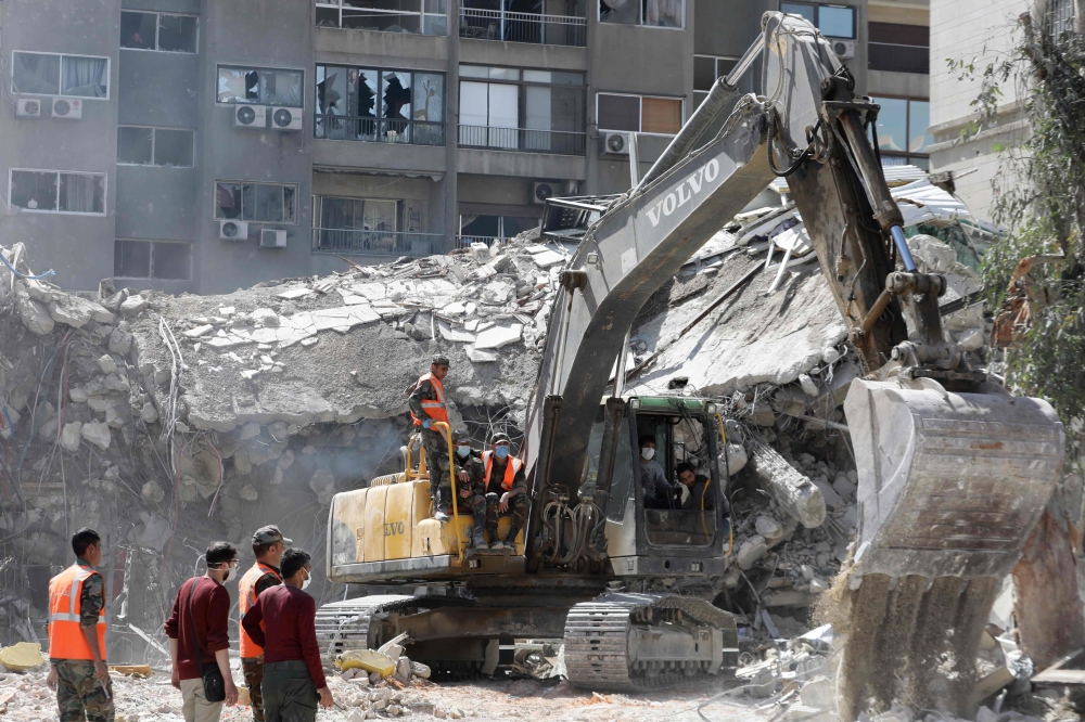 Rescue workers search in the rubble of a building annexed to the Iranian embassy a day after an air strike in Damascus on April 2, 2024. Iran warned arch foe Israel on April 2 that it will punish an air strike that killed seven Revolutionary Guards, two of them generals, at its consular annex in Damascus. — AFP pic 