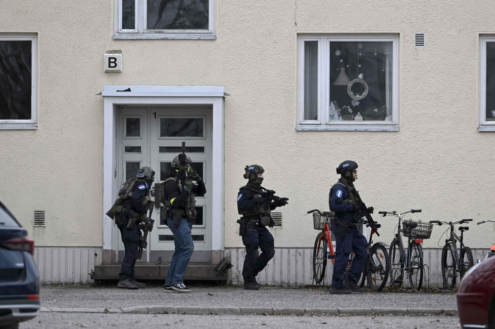 Finnish police at the scene where a child opened fire, killed one and injured two other children. — AFP pic