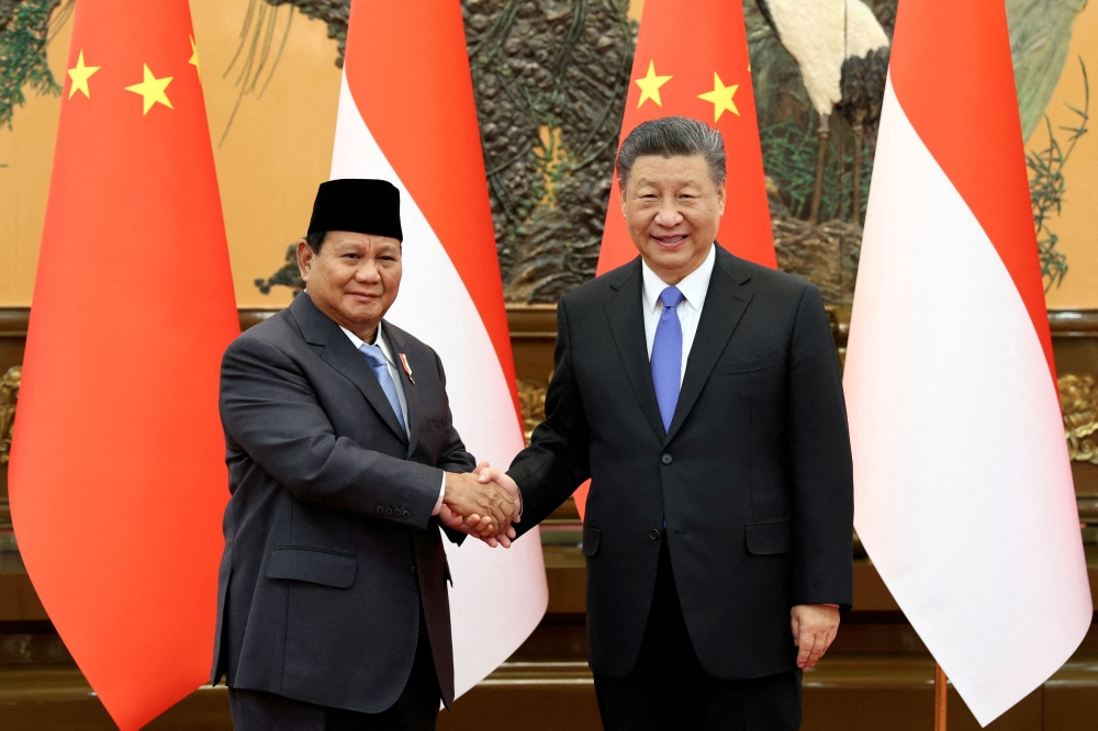 Chinese President Xi Jinping and Indonesia's President-elect Prabowo Subianto shake hands at the Great Hall of the People in Beijing, China April 1, 2024. –– China Daily via Reuters pic