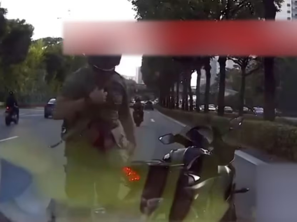 A screengrab of the motorcyclist caught on video claiming to be from the military police. — YouTube screengrab via TODAY