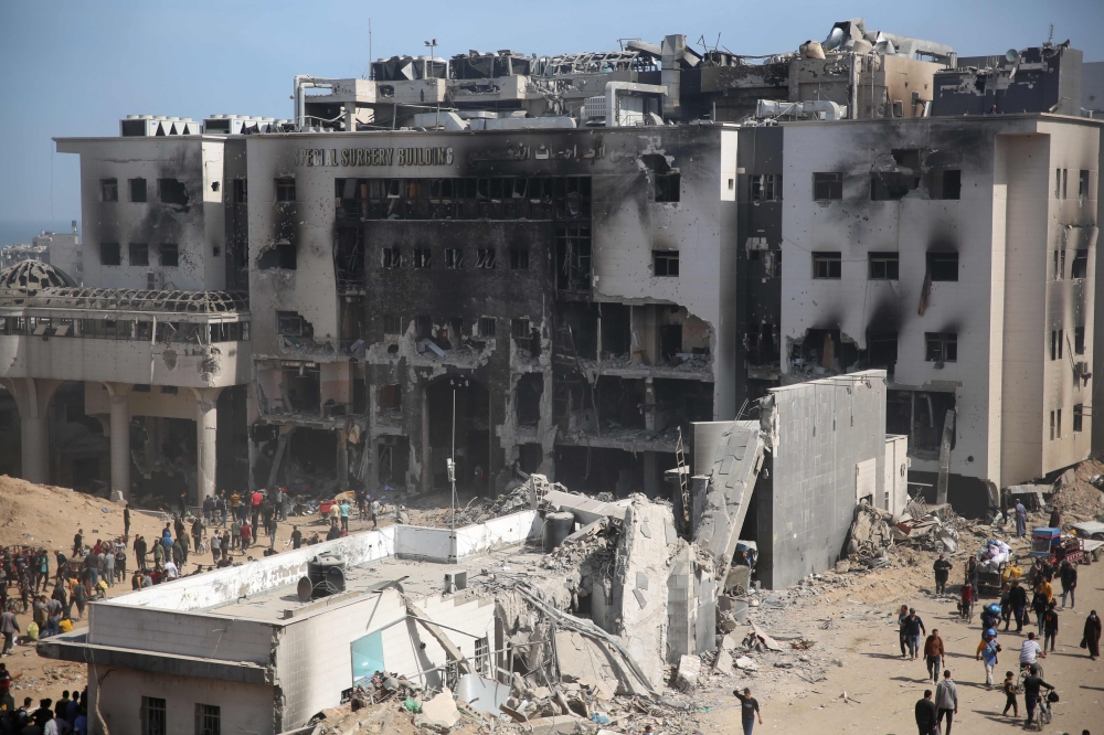 Palestinians inspect the damage at Gaza's Al-Shifa hospital after the Israeli military withdrew. — AFP pic