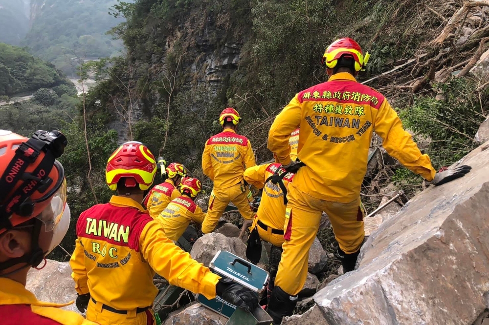 This handout from the Pingtung County Fire and Emergency Services taken and released on April 4, 2024, shows search and rescue personnel working on a mountainside during the search for the body of a hiker in Hualien. — AFP pic/Pingtung County Fire and Emergency Services