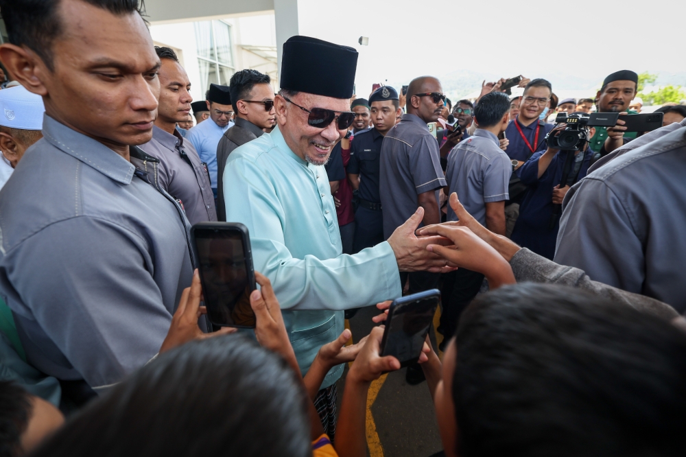 Prime Minister Datuk Seri Anwar Ibrahim shakes hands with a congregant after performing Friday prayers at the Sungai Ara Al-Huda Mosque in Bayan Lepas, April 5, 2024. — Bernama pic   