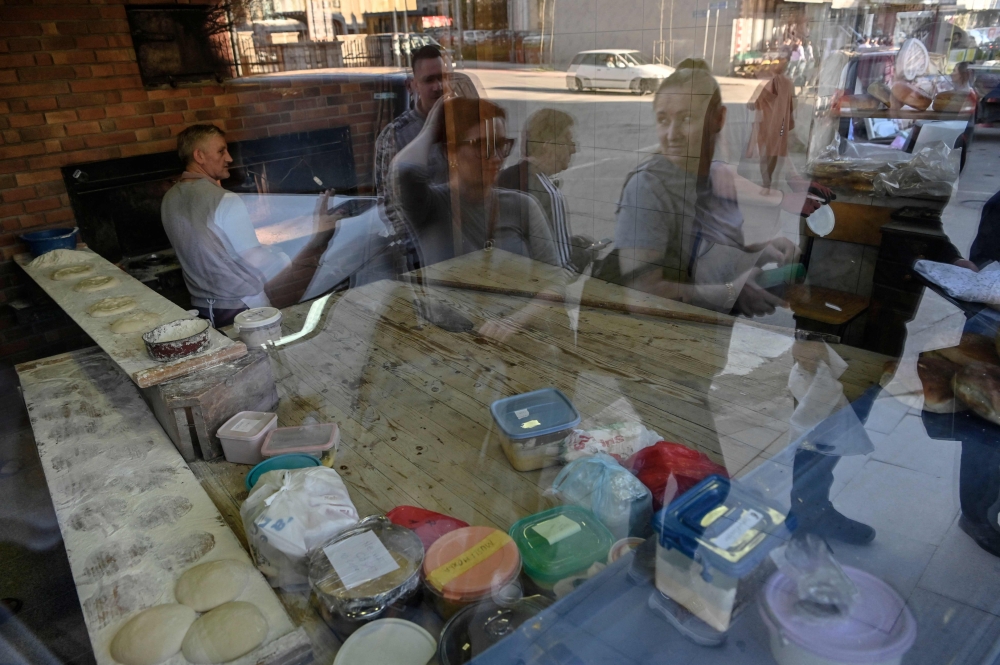 Clients wait to buy traditional 'Pitalka' breads for the the holy month of Ramadan in the southern town of Prizren, Kosovo March 30, 2024. — AFP pic