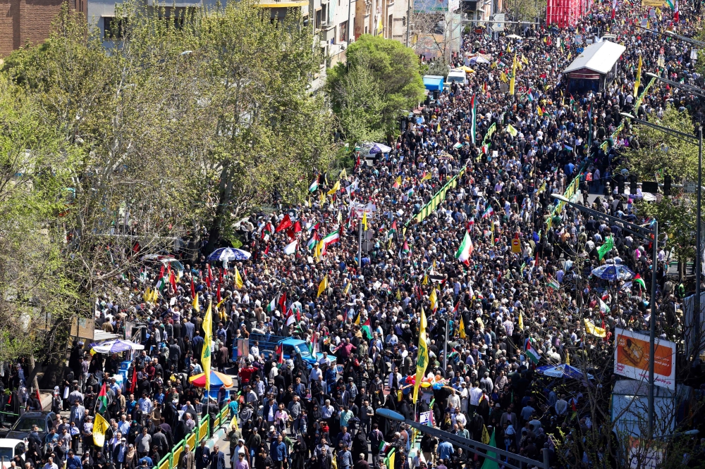 People attend the funeral procession for seven Islamic Revolutionary Guard Corps members killed in a strike in Syria, which Iran blamed on Israel, in Tehran April 5, 2024. — AFP pic