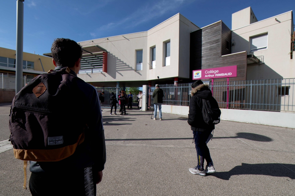 Students arrive on April 4, 2024 in Montpellier, southern France, at the College Arthur-Rimbaud secondary school a day after a 14-year-old girl was assaulted outside the school. Three minors, at least one of whom attended the same establishment, were taken into custody on April 3 for attempted murder of a minor, according to a press release from the Montpellier public prosecutor's office. — AFP pic