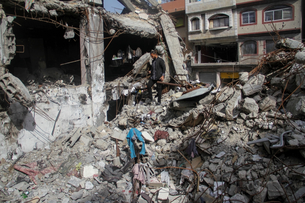 A man walks through the rubble of his shop which was destroyed in an Israeli strike, in Jabalia in the northern Gaza Strip March 31, 2024. ― Reuters pic