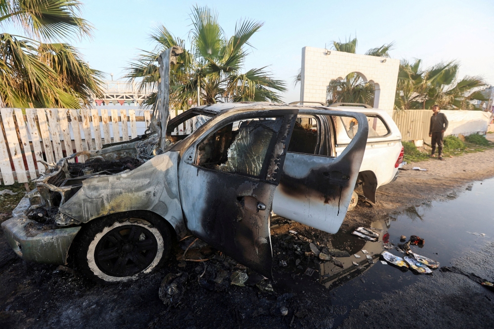 A man looks at a vehicle where employees from the World Central Kitchen (WCK), including foreigners, were killed in an Israeli airstrike in central Gaza Strip April 2, 2024. ― Reuters pic