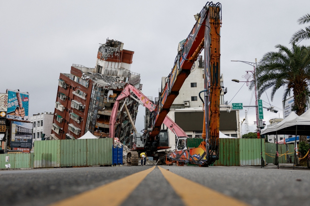 Workers demolish a damaged building following the earthquake, in Hualien April 6, 2024. — Reuters pic  