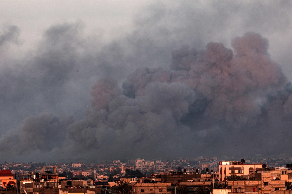 This picture taken from Rafah shows smoke billowing over Khan Yunis in the southern Gaza Strip during Israeli bombardment on January 16, 2024, amid ongoing battles between Israel and the Palestinian group Hamas. — AFP pic