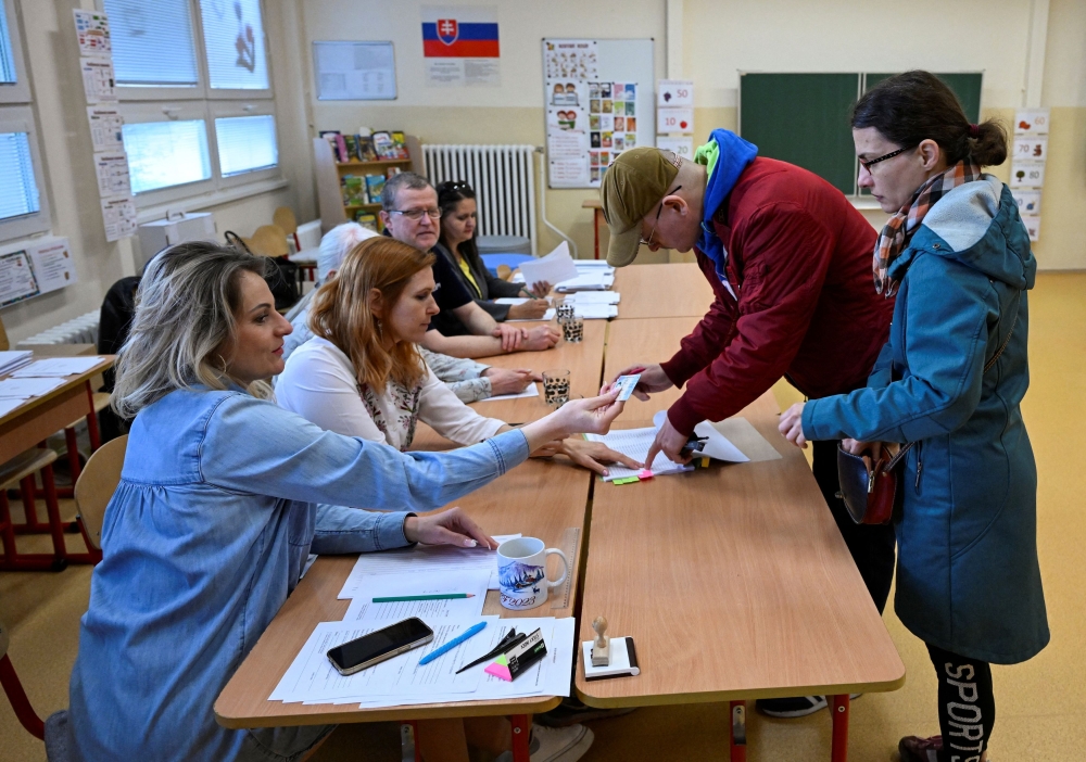 A man prepares to cast his vote during the country's presidential election run-off at a polling station in Senec, Slovakia, April 6, 2024. — Reuters pic  
