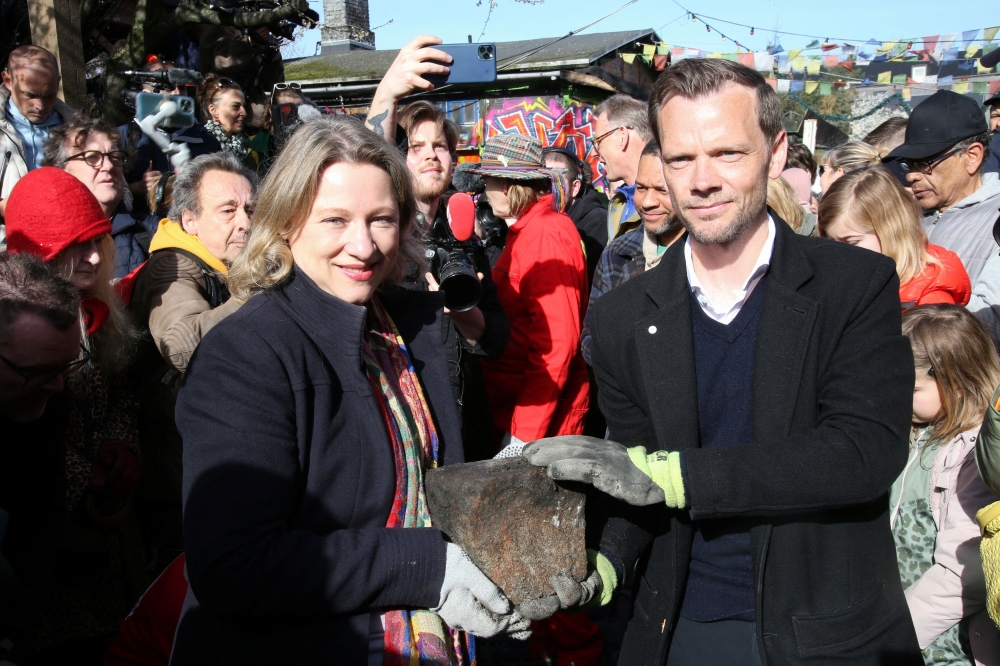 Mayor of Copenhagen Sophie Haestorp Andersen and Danish Justice Minister Peter Hummelgaard hold a cobble stone removed by residents from the area of Freetown Christiania known as the 