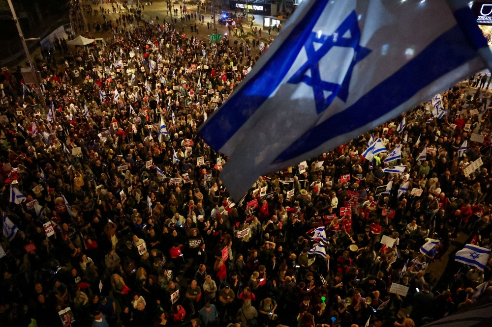 An Israeli flag flutters as people attend a protest against Israeli Prime Minister Benjamin Netanyahu’s government and to call for the release of hostages kidnapped in the deadly October 7 attack on Israel by Hamas from Gaza, in Tel Aviv, Israel, April 7, 2024. — Reuters pic
