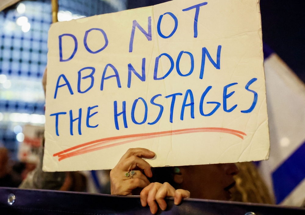 People attend a protest against Israeli Prime Minister Benjamin Netanyahu’s government and to call for the release of hostages kidnapped in the deadly October 7 attack on Israel by Hamas from Gaza, in Tel Aviv, Israel, April 7, 2024. — Reuters pic