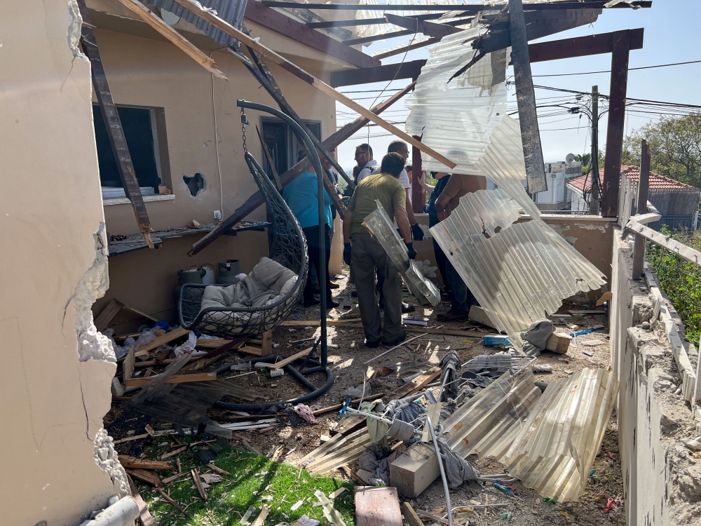 File photo of people gathering at a house that was struck, according to Israel’s army, after a number of launches from Lebanon, amid ongoing cross-border hostilities between Hezbollah and Israeli forces, in Shlomi, near Israel’s border with Lebanon in northern Israel, April 4, 2024. — Reuters pic