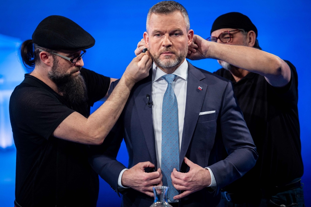 File photo of Peter Pellegrini (centre) preparing for the start of a debate on public television channel RTVS on April 3, 2024 in Bratislava, Slovakia, before the second round of the presidential elections. — AFP pic
