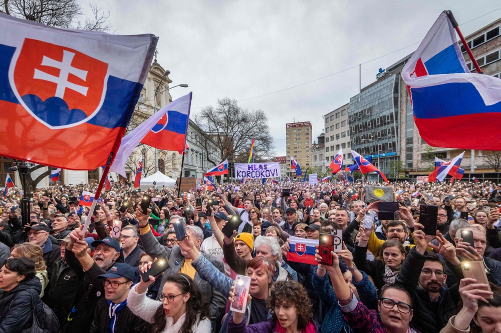 Supporters of Slovakia’s former foreign minister and presidential candidate Ivan Korcok waving the country’s flag during a campaign meeting on April 3, 2024 in Bratislava, Slovakia, before the second round of the presidential elections. — AFP pic