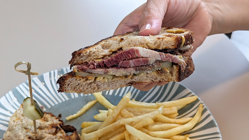 A cross-section of the golden ratio of salt beef, pickles, a smidge of mustard and toasted rye bread.