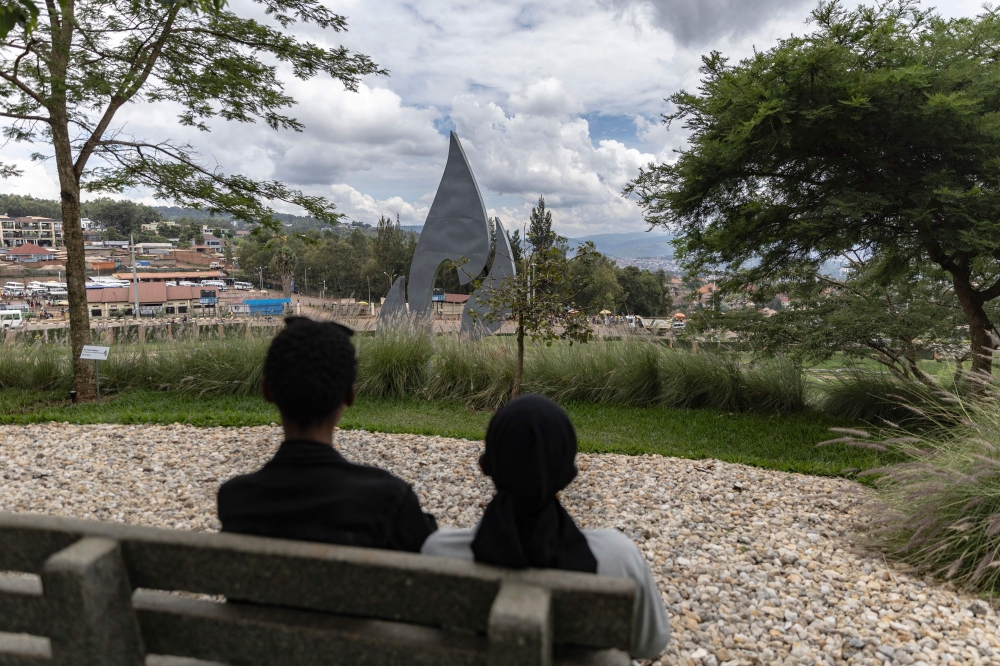 Two women wearing black grieve next to the monument of the Flame of Remembrance at the Nyanza Genocide Memorial Center in Kigali ahead of the 30th commemoration of the 1994 Genocide against Tutsi people on April 5, 2024. — AFP pic