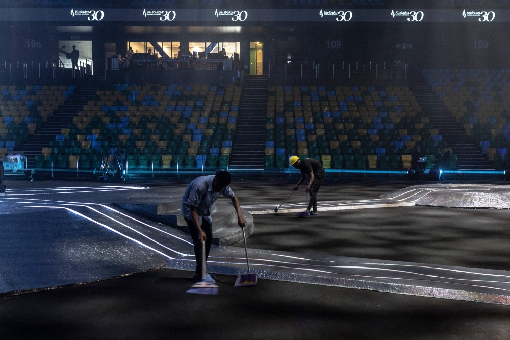 Two men clean at the BK Arena in Kigali ahead of the 30th commemoration of the 1994 Genocide against Tutsi people on April 5, 2019. — AFP pic