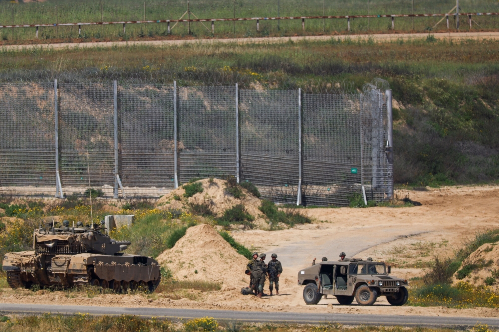 File photo of Israeli soldiers standing near military vehicles, amid the ongoing conflict between Israel and the Palestinian Islamist group Hamas, near the Israel-Gaza border, as seen from Israel, April 4, 2024. — Reuters pic