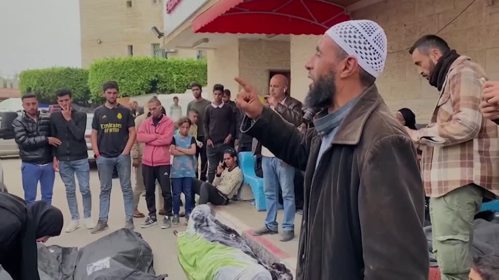 Islam Abu Isaeed is often seen praying over the bodies of people killed in Israel's offensive. — Video screenshot by Reuters