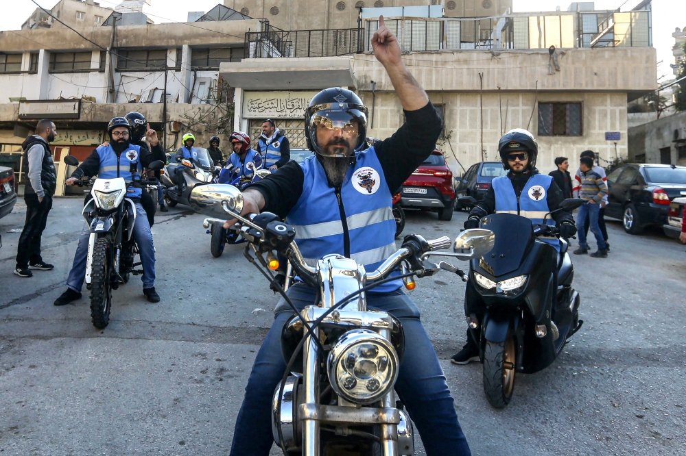 Members of motorcycle club Hope Bikers Syria help distribute 