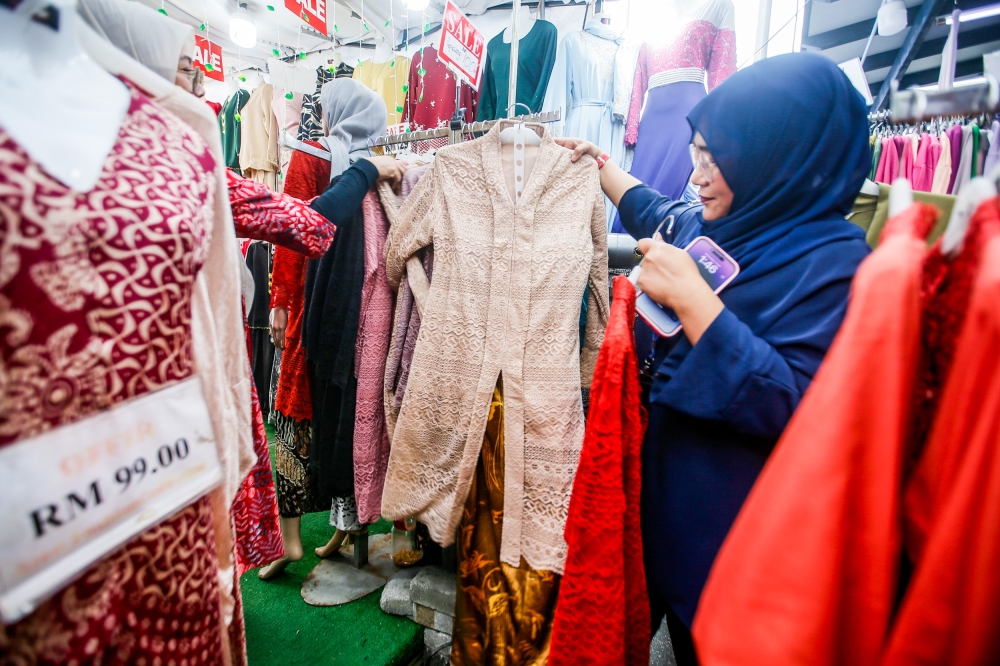 People shop for clothes to celebrate Hari Raya Aidilfitri at Lorong Tuanku Abdul Rahaman, Kuala Lumpur April 3, 2024. — Picture by Hari Anggara