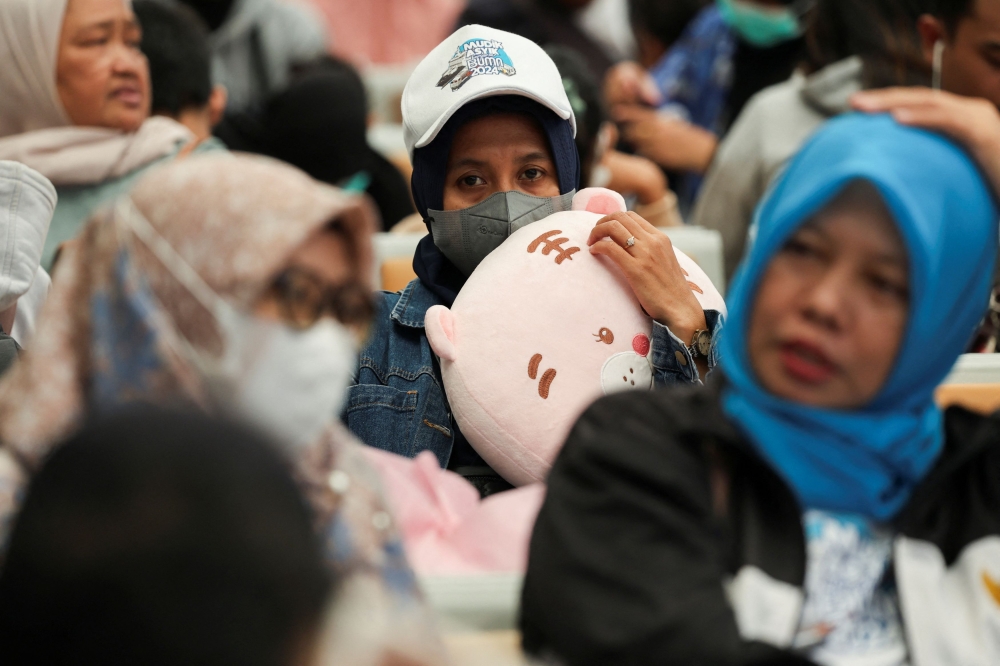 Passengers wait to board a train at the train station to return to their hometown, an activity locally known as ‘mudik’, ahead of the Hari Raya Aidilfitri celebration, in Jakarta April 3, 2024. — Reuters pic