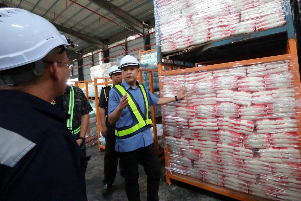 Domestic Trade and Cost of Living Minister Datuk Armizan Mohd Ali (right) inspects the sugar supply at Gudang Sazarice Sdn Bhd in the Kota Kinabalu Industrial Park April 9, 2024. — Bernama pic