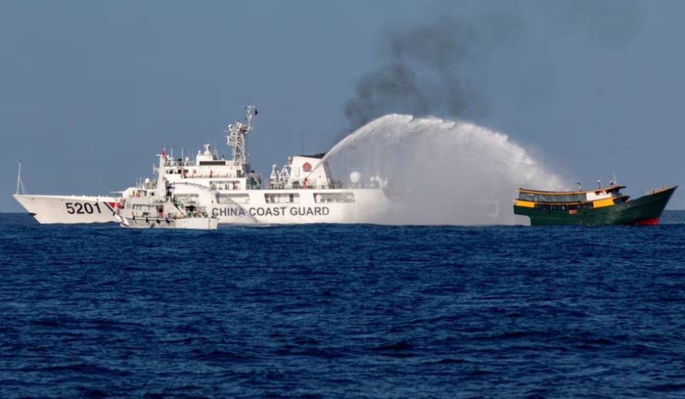 Chinese Coast Guard vessels fire water cannons towards a Philippine resupply vessel Unaizah May 4 on its way to a resupply mission at Second Thomas Shoal in the South China Sea, March 5, 2024. — Reuters pic