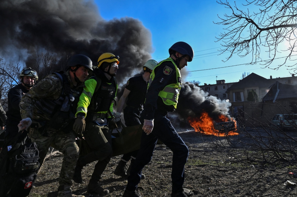 Emergency workers carry an injured woman at a site of a Russian missile strike, amid Russia's attack on Ukraine, in Zaporizhzhia, Ukraine April 5, 2024. — Reuters pic 